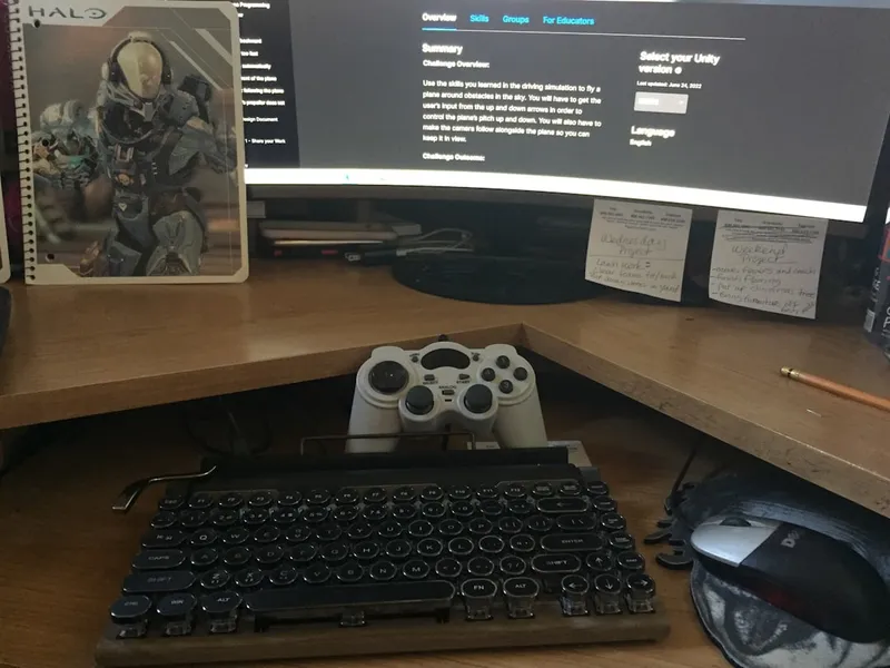 Office desk with keyboard, monitor, mouse and game controller (by Diane Newbill).